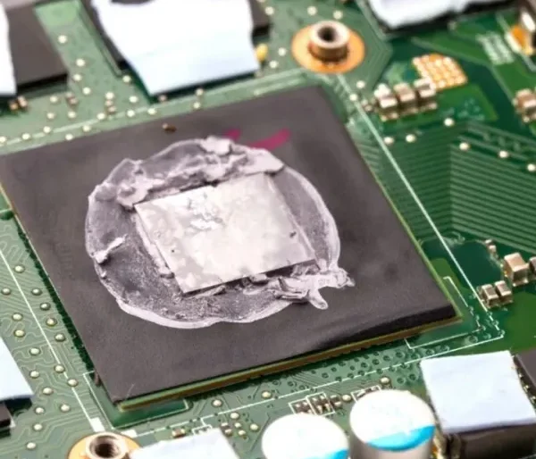 Disassembled laptop showing dust buildup inside the ventilation system, highlighting the importance of laptop fan cleaning and dust removal.